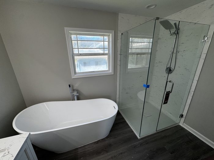 Bathroom with a freestanding tub and a frameless glass shower
