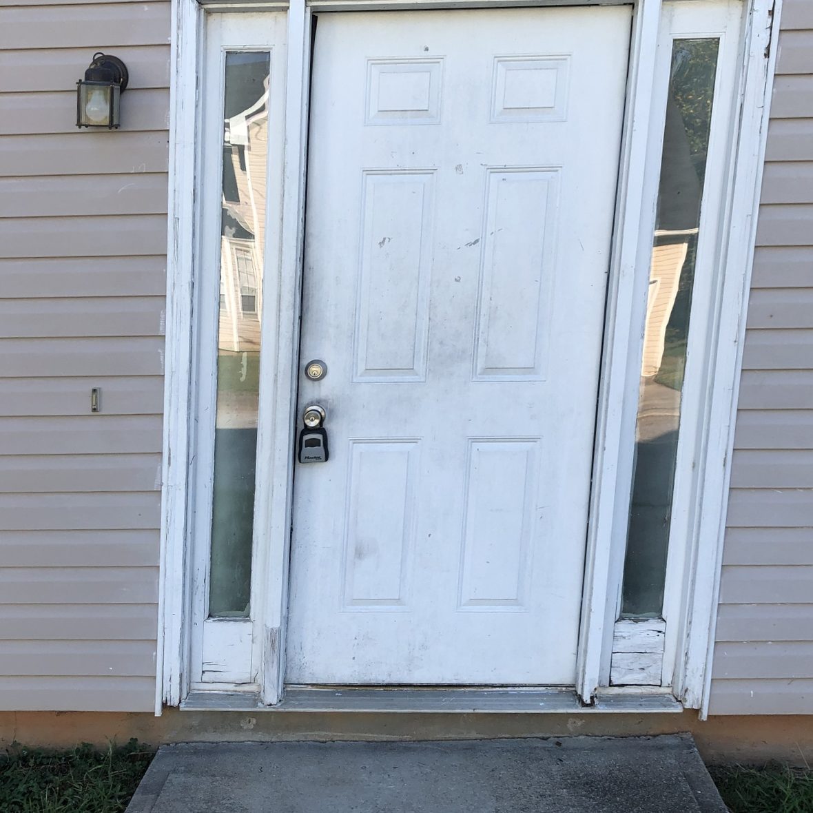 Before: a worn white entry door with a weathered frame