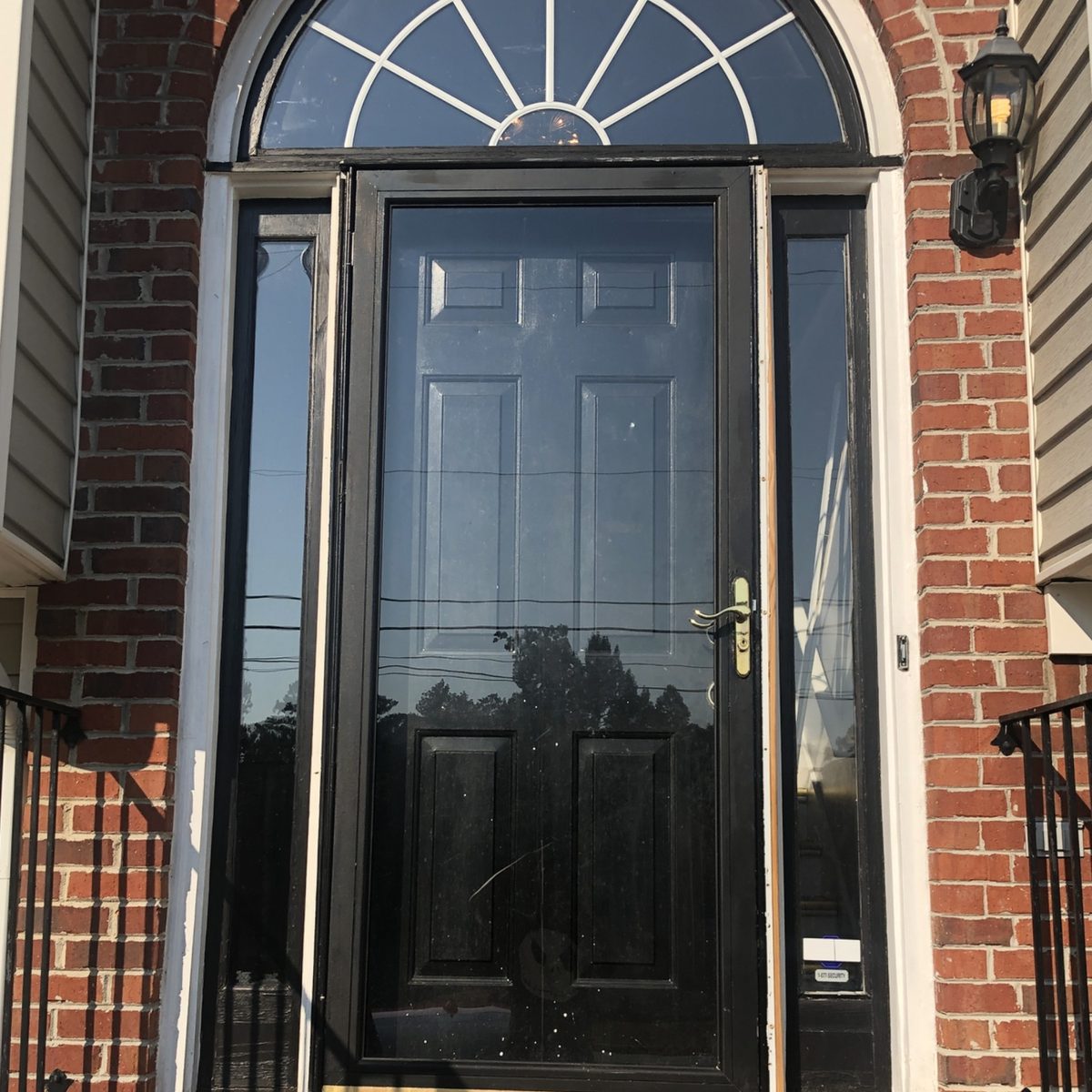 Before: a black front door under an arched window