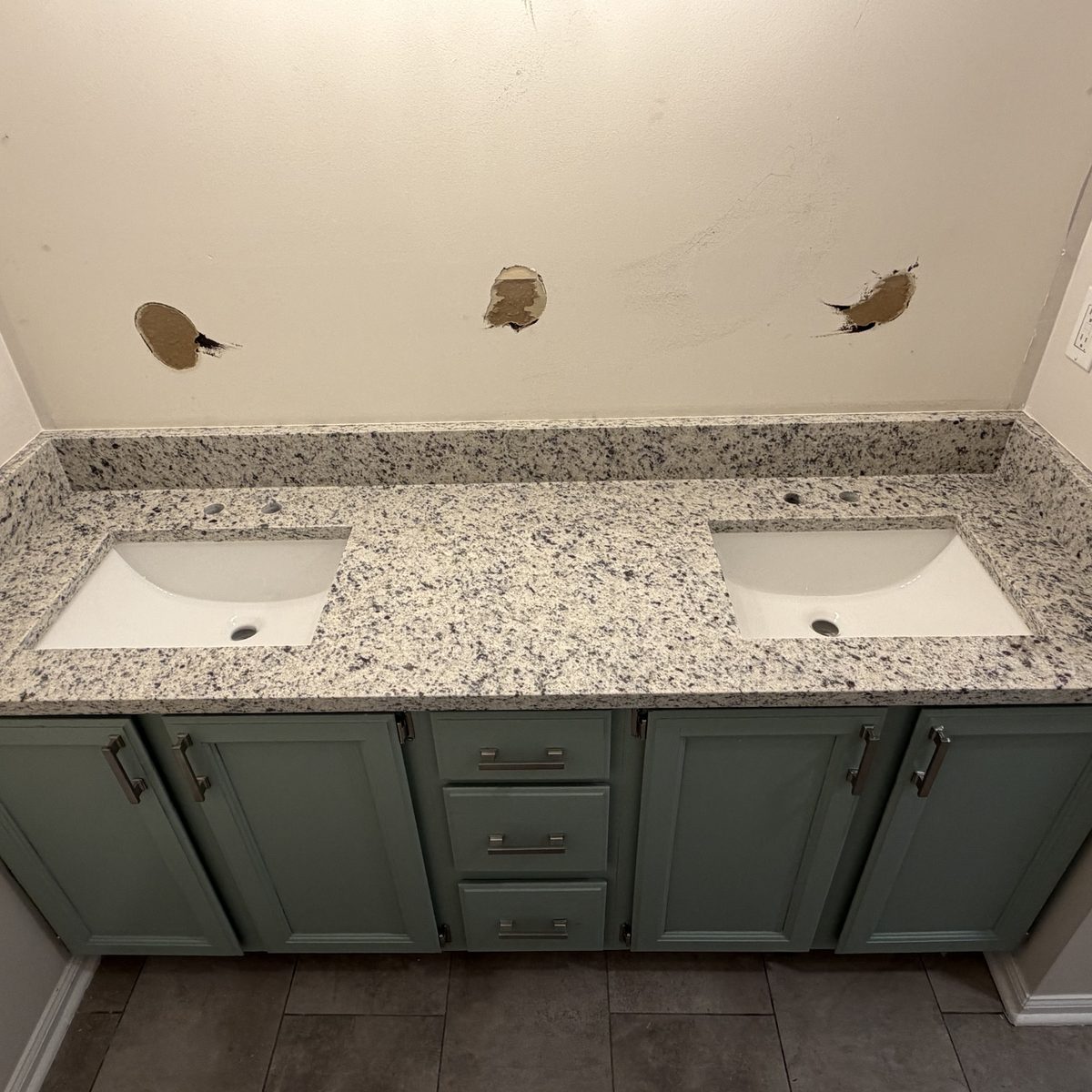 After: the same vanity with white undermount sinks installed